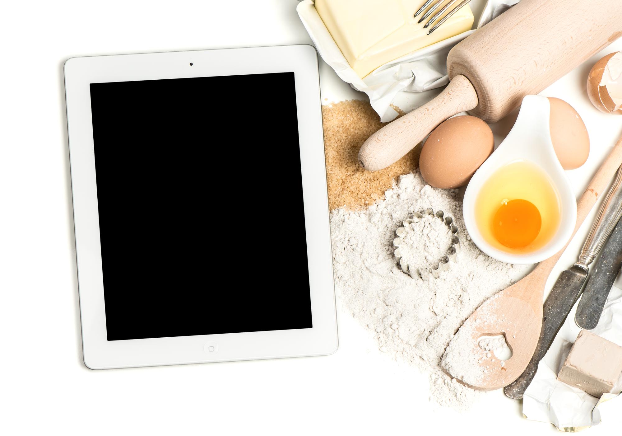 Virtuvės darbo stalas su ingredientais ir planšetė